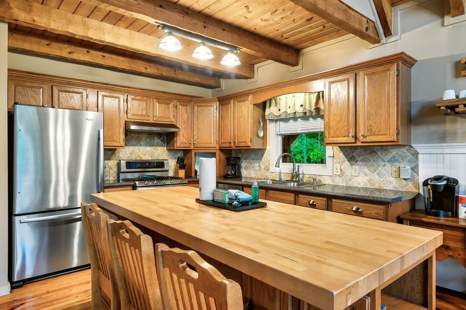Full kitchen with stainless steel appliances, butcher block island