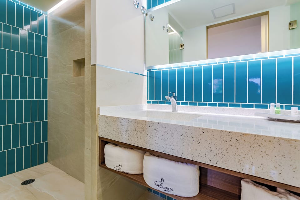 Deluxe One King Bed | Bathroom | Shower, rainfall showerhead, designer toiletries, hair dryer