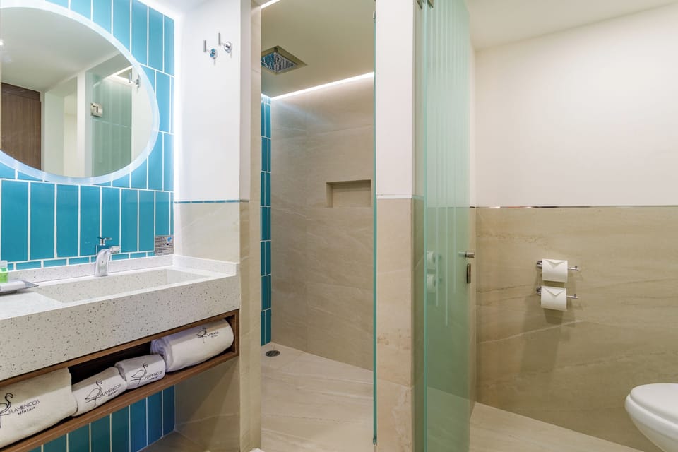 Deluxe One King Bed | Bathroom | Shower, rainfall showerhead, designer toiletries, hair dryer