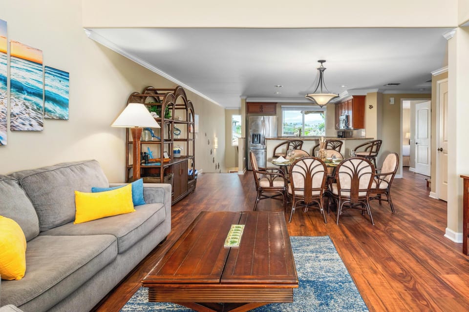 - Cozy living room flows seamlessly into dining space and open kitchen - Wood flooring and warm lighting enhance the tropical, homey atmosphere - Ideal for group meals, movie nights, and easy conversation together