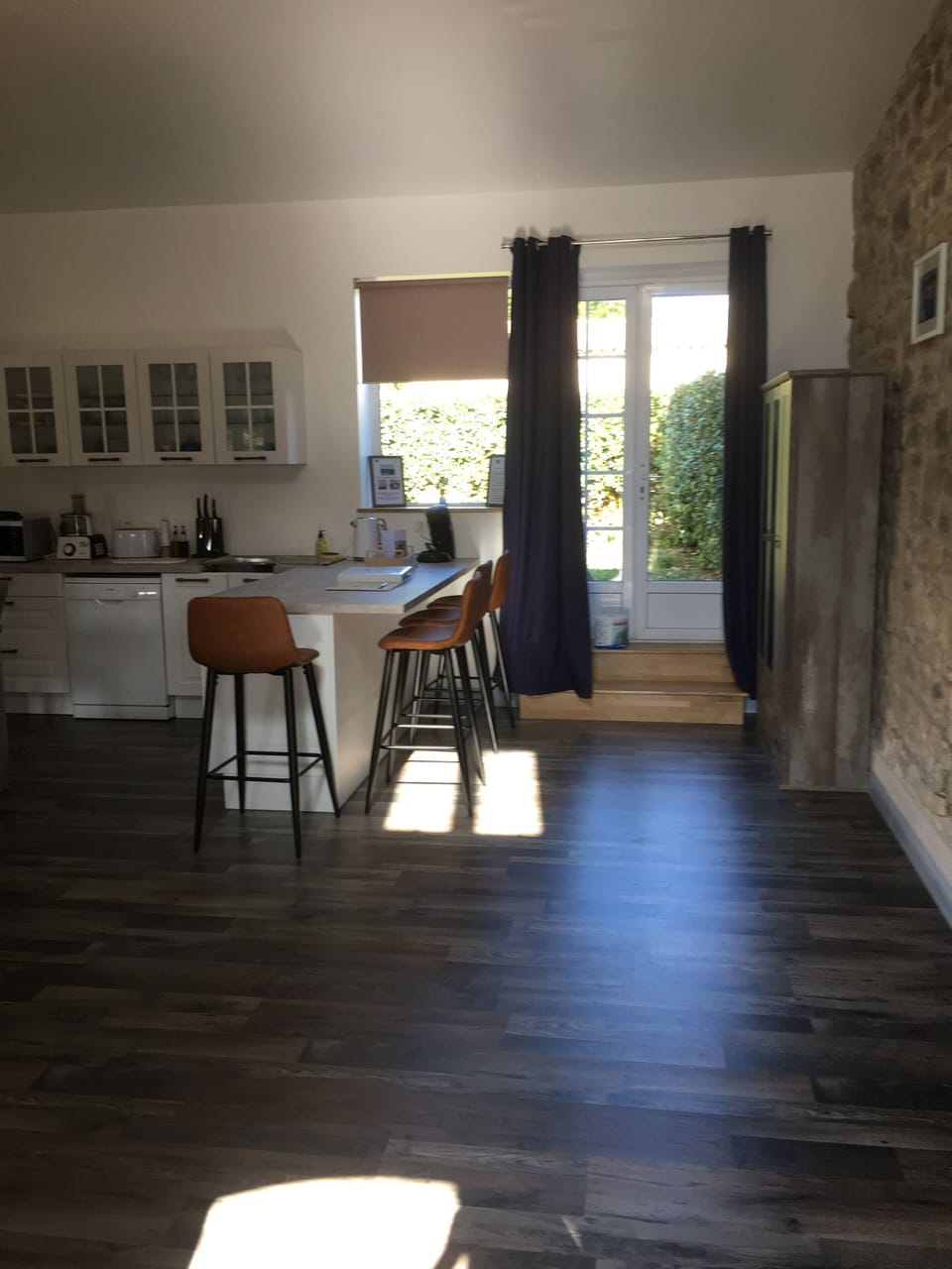 Sit at the bar area which opens out onto your private garden