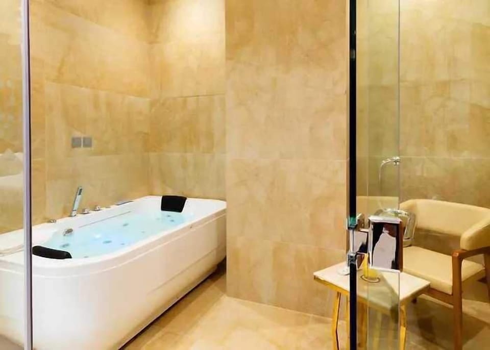 Deluxe Room, 1 Queen Bed | Bathroom | Separate tub and shower, rainfall showerhead, designer toiletries