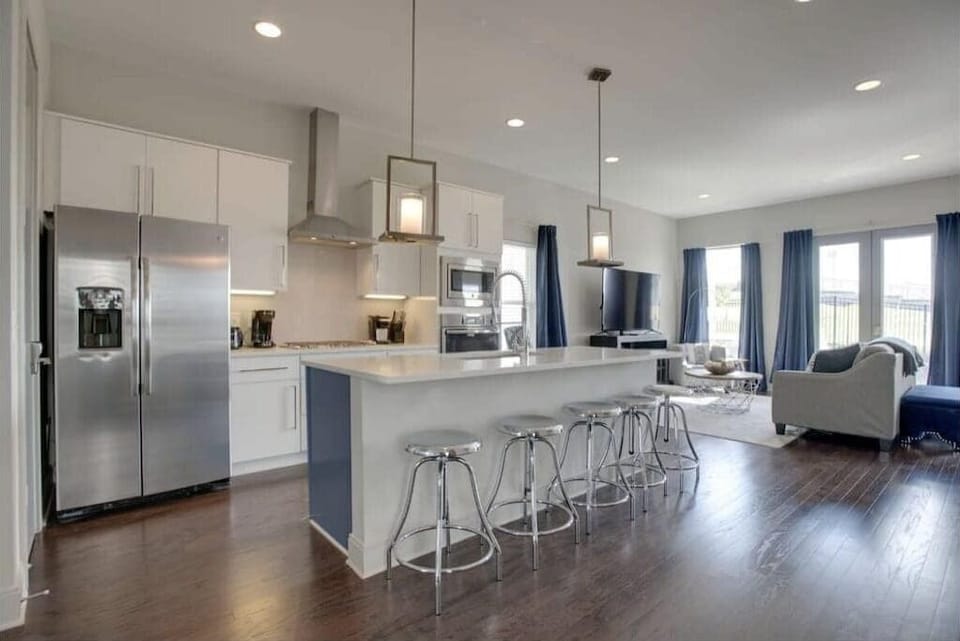 Prepare meals and gather around the spacious kitchen island with seating for five, perfect for dining and conversation.