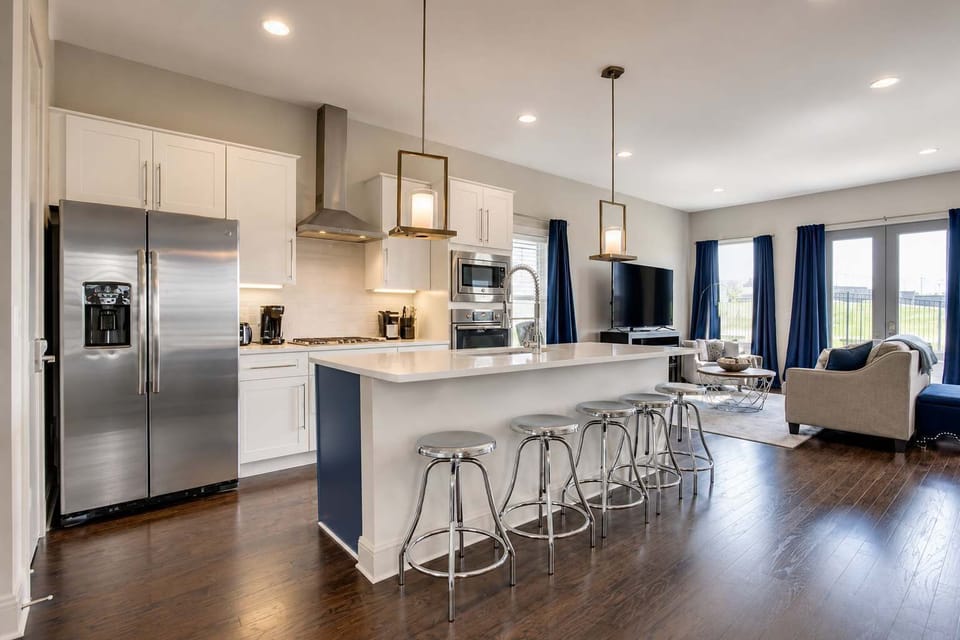 Spacious kitchen island with seating for five, perfect for cooking, dining, and gathering together.