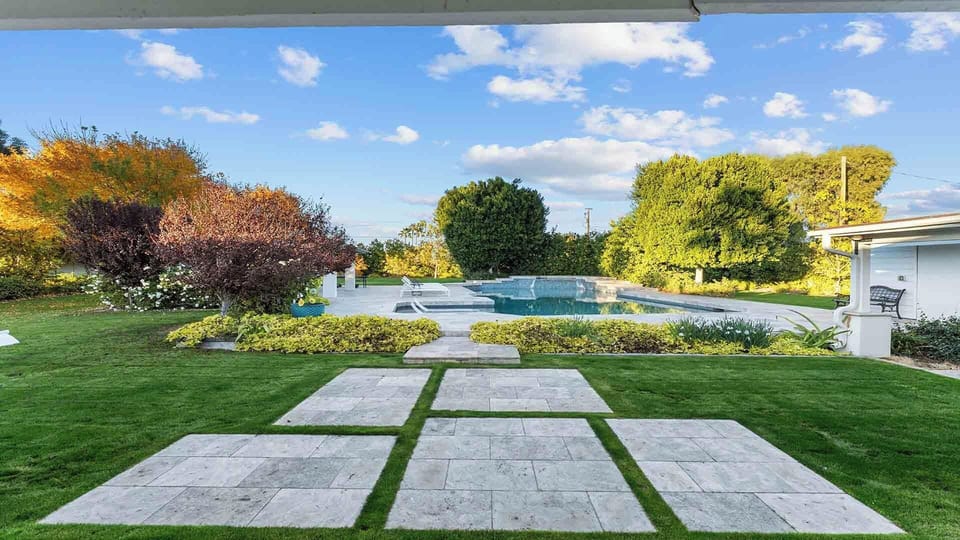 Step out from the kitchen to this lush backyard and enjoy the views.