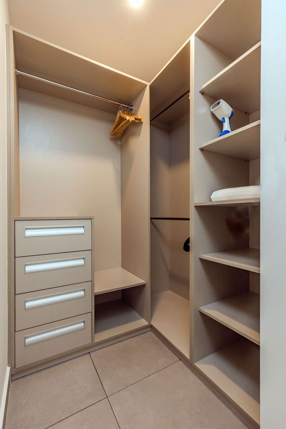 Your private walk-in closet provides ample space with organized shelving, hanging rods, and built-in drawers to keep your belongings neatly stored during your stay.