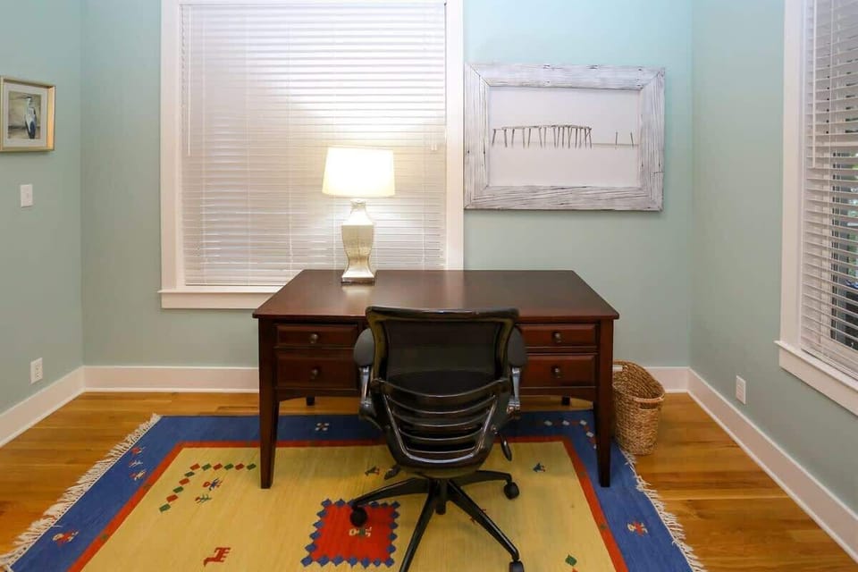 - Brightspace with a desk, perfect for work or a quiet retreat - Features a colorful rug and stylish artwork, creating a comfortable and inspiring environment - Plenty of natural light streaming in, ideal for focusing or enjoying a moment of producti