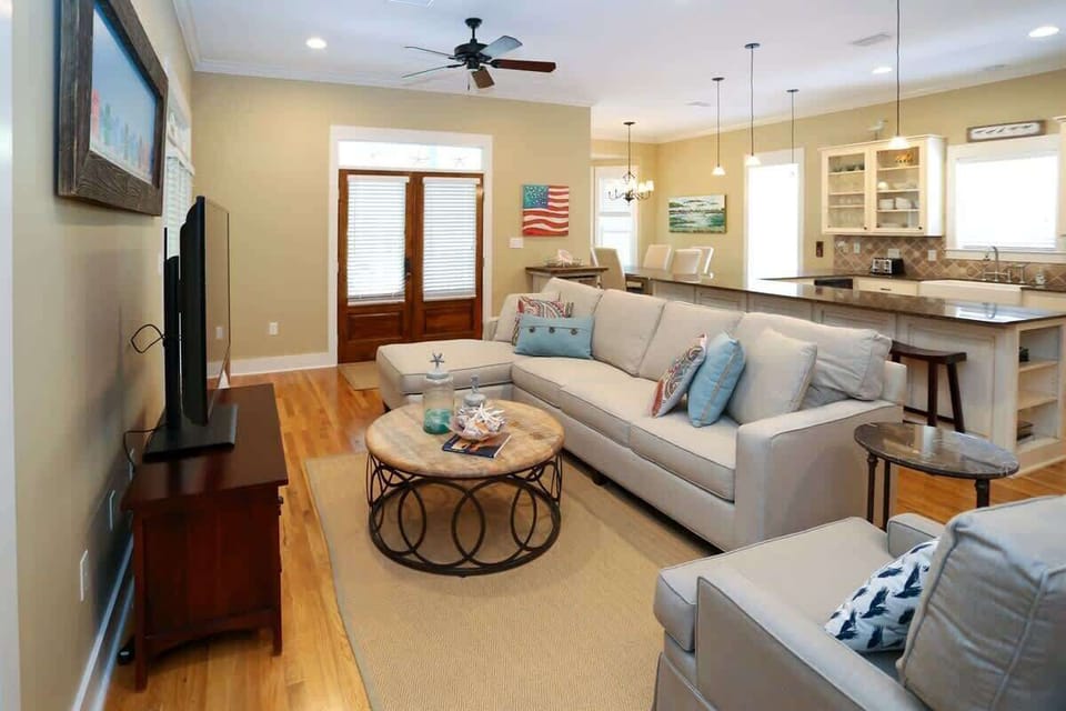 - Living space with cozy seating, perfect for movie nights or casual conversation - Decorated with coastal inspired accents & artwork, creating a laid back, beachy vibe - Open floor plan connects seamlessly to the kitchen & dining areas for socializi