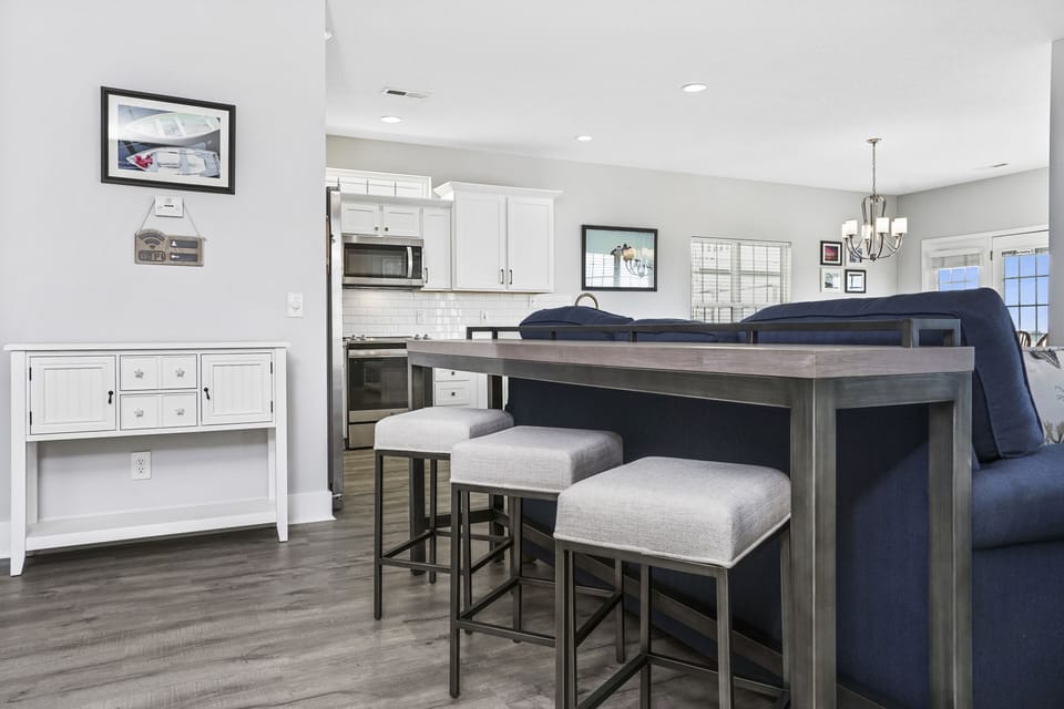 You'll love gathering around this sleek kitchen island with comfortable seating while preparing meals in your fully equipped space.