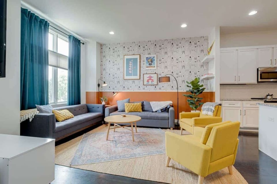 Effortlessly stylish and spacious, this living room is the heart of the home, blending modern comfort with seamless access to warm, inviting spaces.