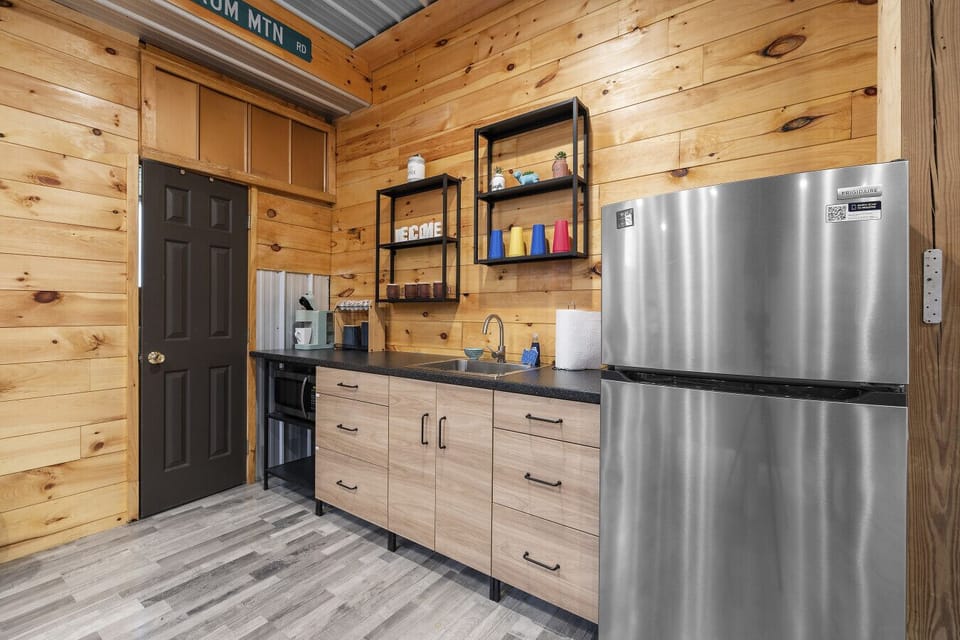Quick and convenient! The downstairs kitchenette, adjacent to the downstairs living space, comes with a fridge and a sink—perfect for prepping snacks or light meals. An additional Keurig is available for your convenience- coffee anytime, anywhere!