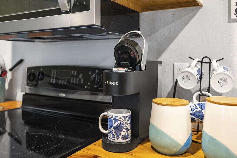 Cook like a pro in our fully equipped upper-level kitchen! Featuring a Keurig, microwave, oven, range, and plenty of storage for all your culinary needs.