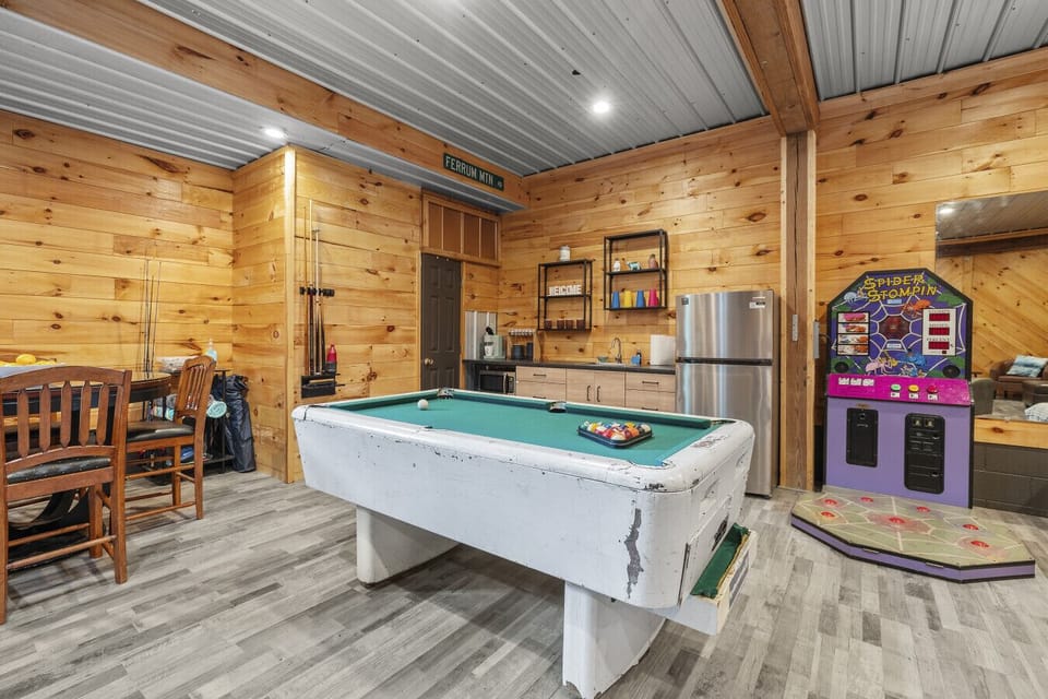 Fun central! The downstairs boasts plenty of lounging space, a pool table, some arcade games, and air hockey. Not to mention a large flat screen Roku TV. The ultimate hangout space!