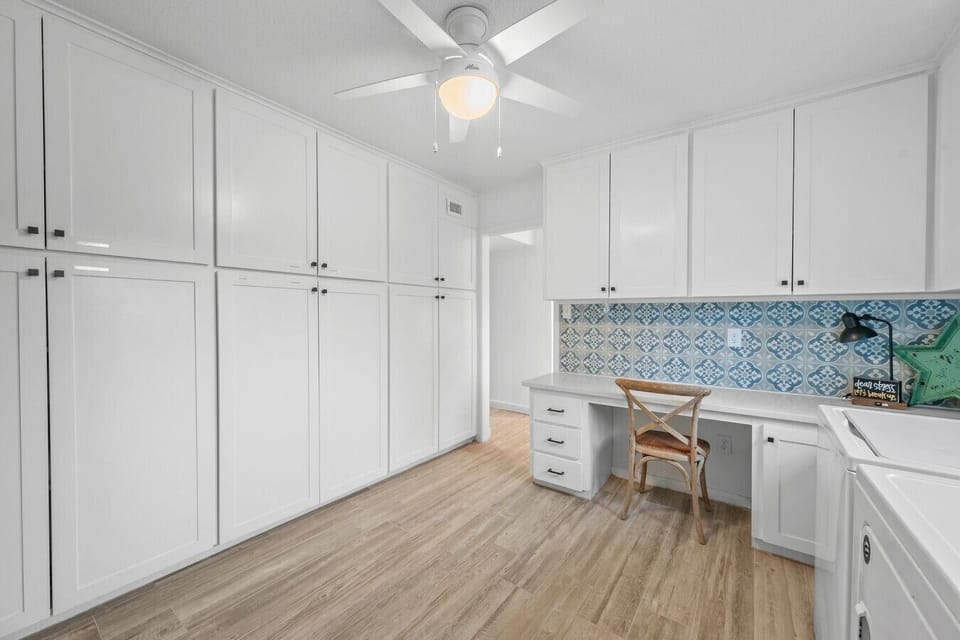 Office in the laundry room with quartz counter tops and chair