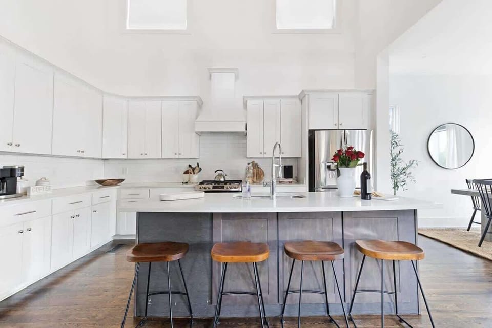 The kitchen island has bar stool seating for 4 guests