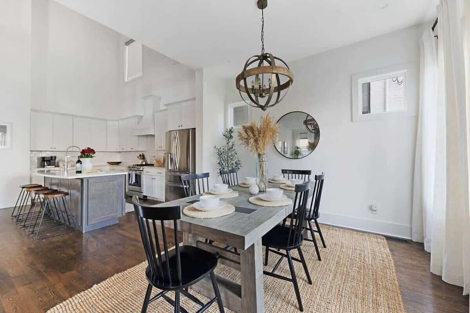 
The large farm-style dining table and open concept design create an inviting space, perfect for great conversation.