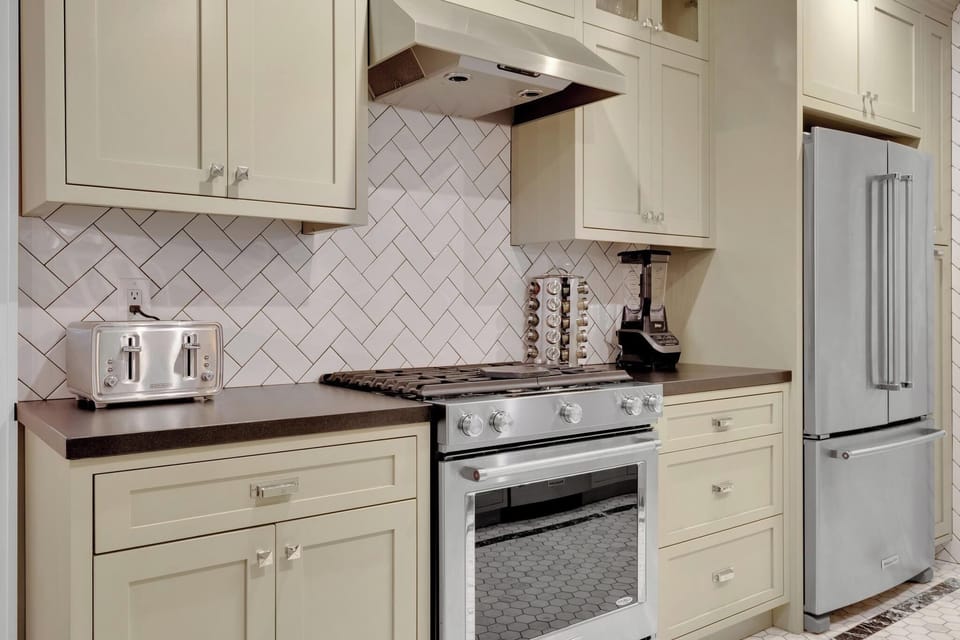 Kitchen with oven and large fridge.
