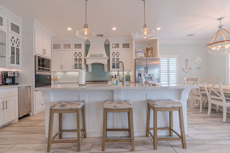 Gourmet kitchen with coffee bar, ice maker, and wine cooler in the open layout.