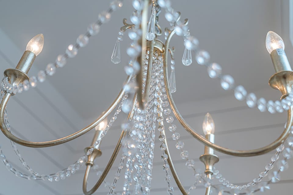 Feel like royalty with the chandelier over the soaking tub. Master bathroom also has a custom tiled shower.