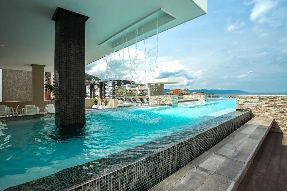 Swim under the shade of sleek architectural overhangs, enjoying high-altitude breezes and panoramic perspectives over the town.