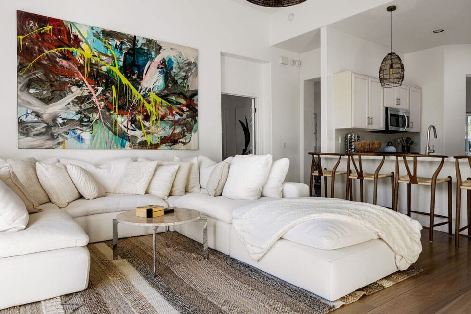 Open concept living with a cozy sectional and breakfast bar perfect for family hangouts.