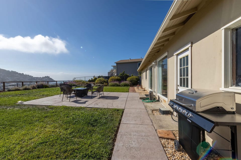 Terrace with grill, dining set, and stunning ocean view
