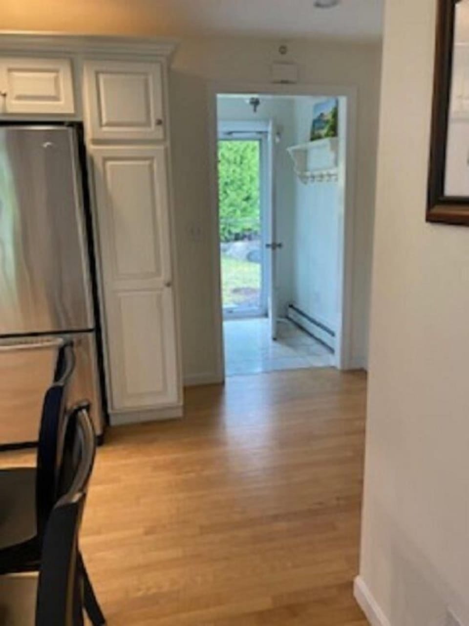 Entrance of home, half-bath is located behind kitchen