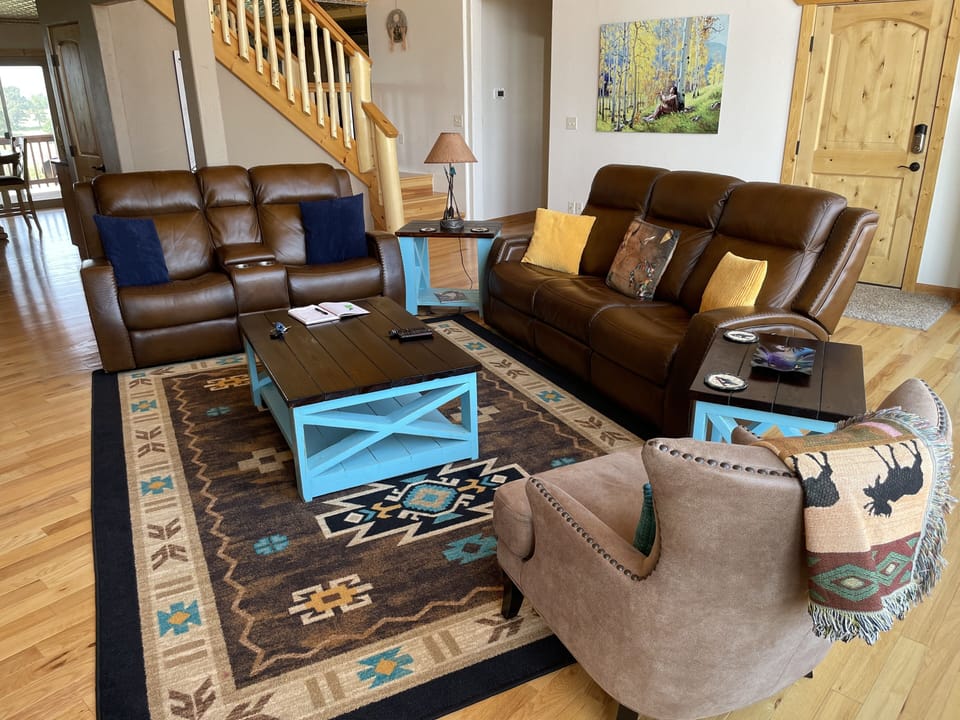 Living room in Native decor.   Pine door is front entry, stairs to the loft