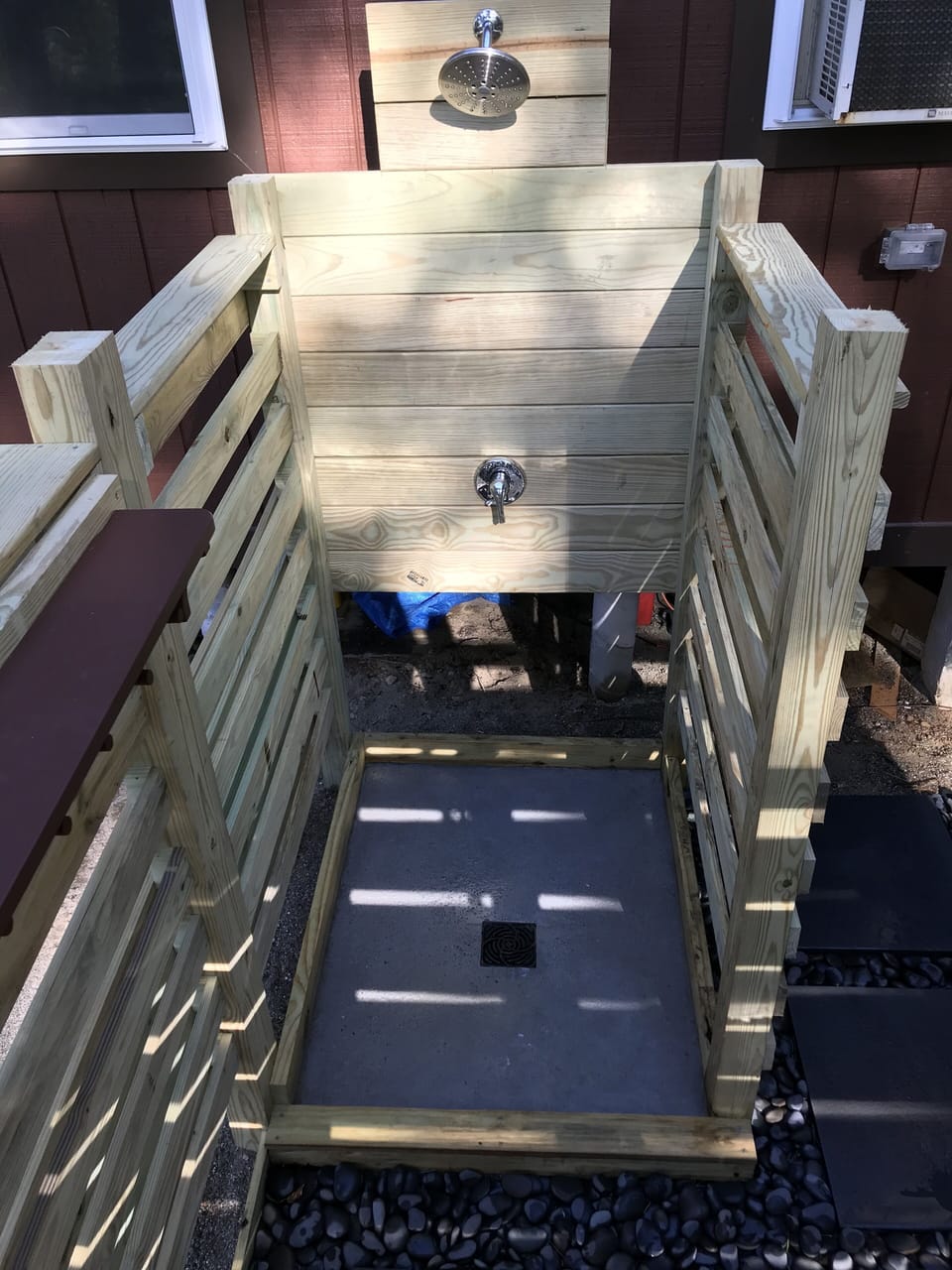 Outdoor shower has lights for night time bathing.