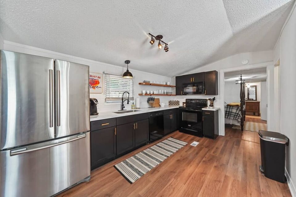 Fully equipped kitchen with full-size fridge, stove, dishwasher, and coffee bar