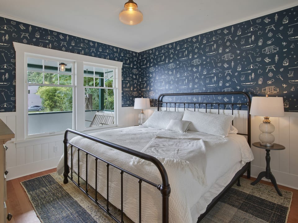 Bedroom on the main floor with a king bed, closet and dresser. 
