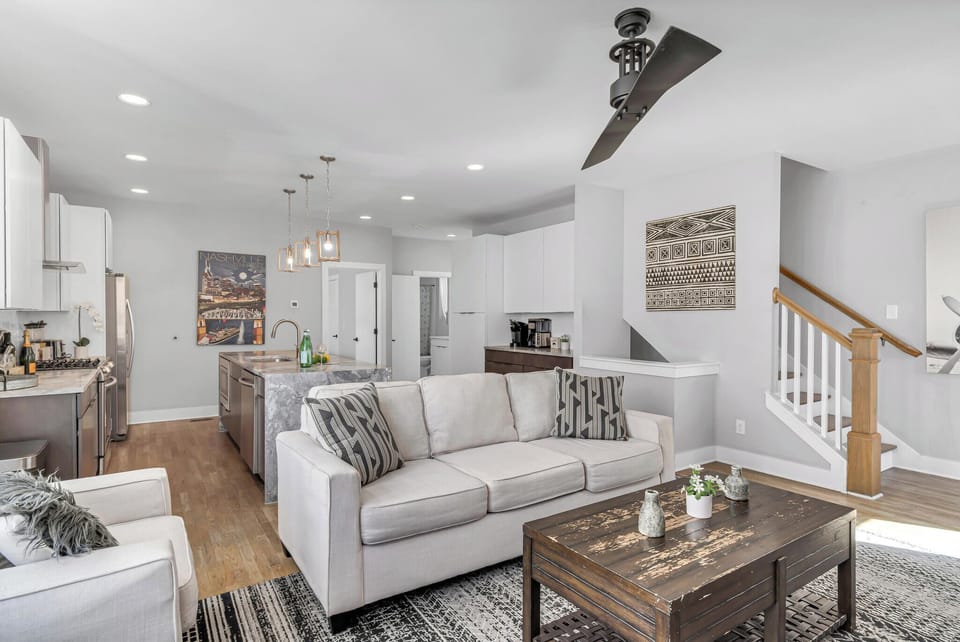 Relax on a cozy off-white sofa with stylish accent pillows, perfect for unwinding after a day of exploring.