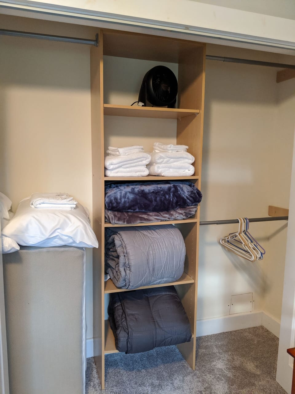 Extra bedding, towels, and a fan in each bedroom