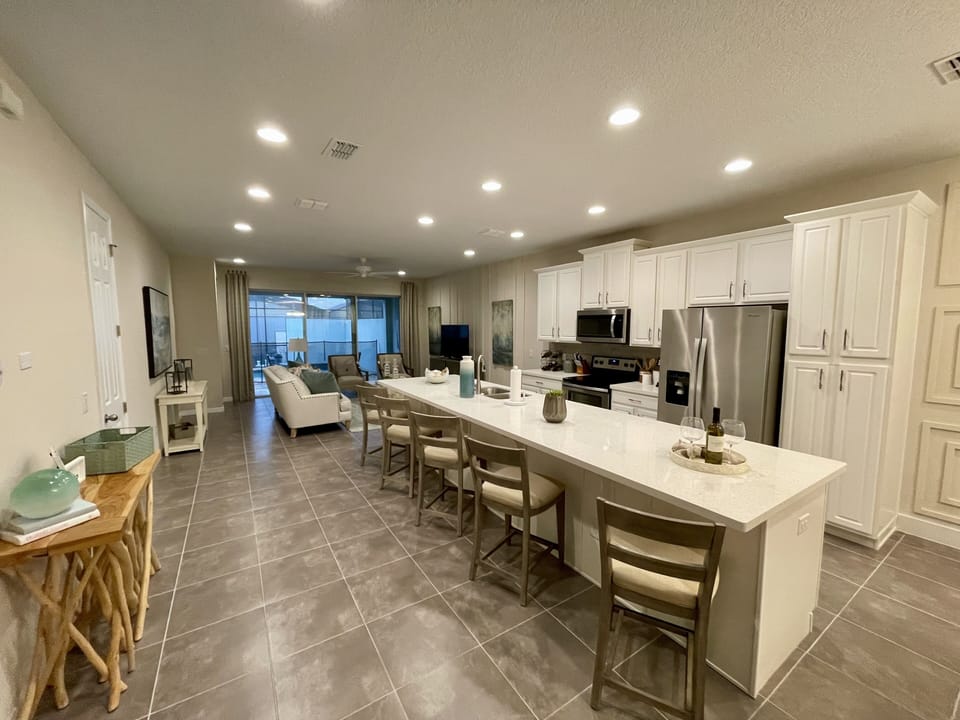 Entry looking at open concept kitchen and living area...both overlooking pool.