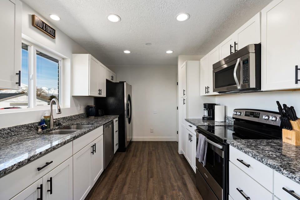 Fully-stocked kitchen on main floor with mountain views out the window.