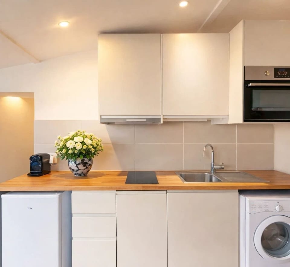 Kitchen complete with utensils and appliances for all your culinary needs.