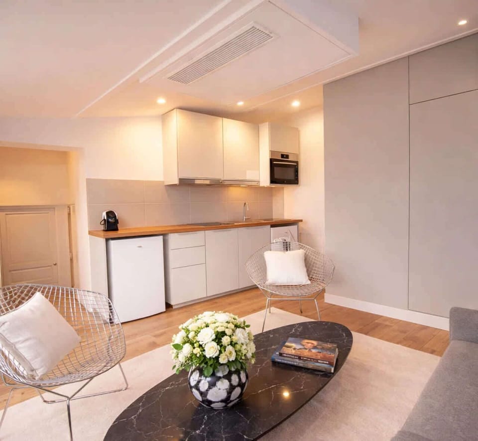 Living room setup includes a sofa and access to the balcony.
