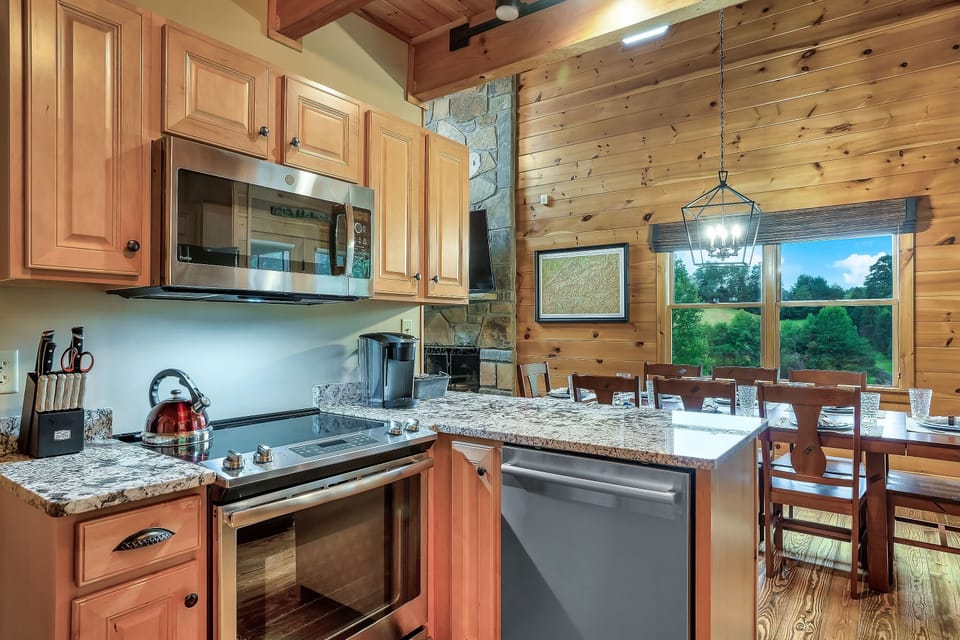 Modern Elegance: Cook Family Meals in Style with Stainless Steel Appliances and Granite Countertops in our Well-Equipped Kitchen