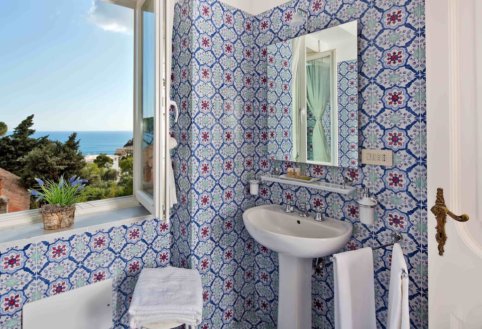 Junior Suite, Sea View | Bathroom | Shower, rainfall showerhead, hair dryer, bathrobes