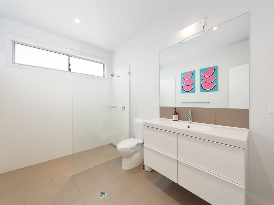 Bright modern bathroom with walk-in shower and sleek vanity