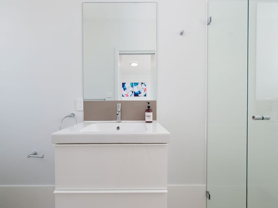Bright modern bathroom with sleek vanity and glass shower