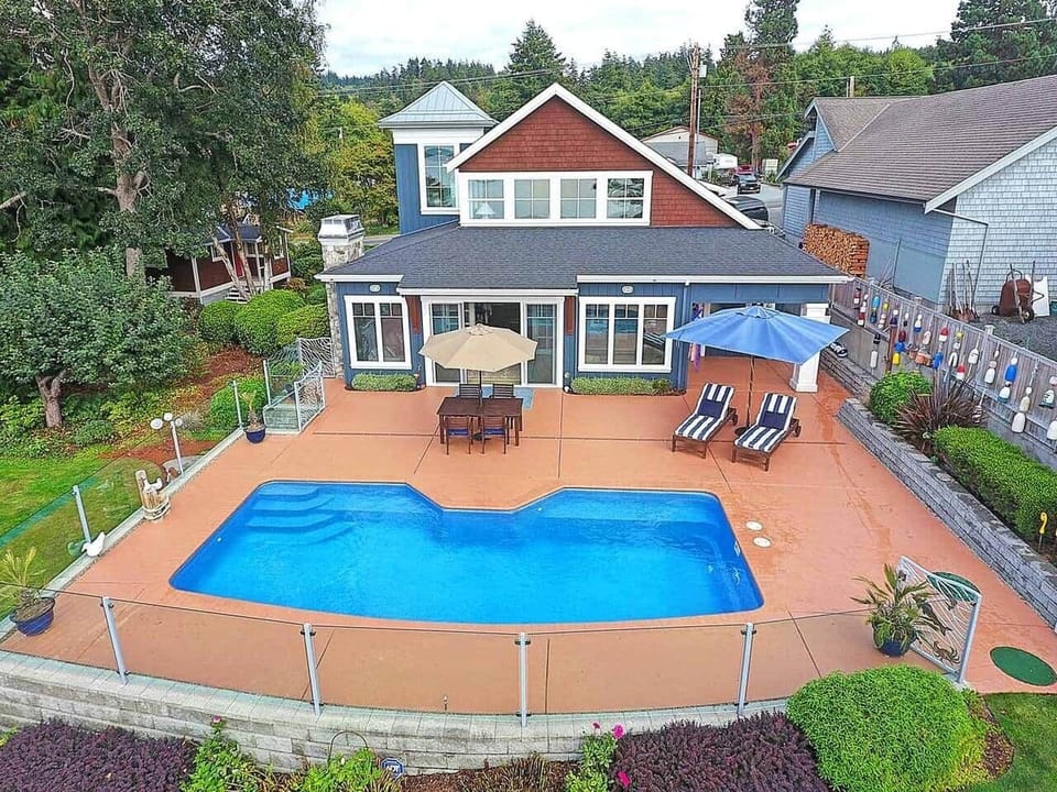 The pool deck provides a perfect place to relax or splash. The glass wall on separating the property from the neighbors has been replaced with a privacy planter.