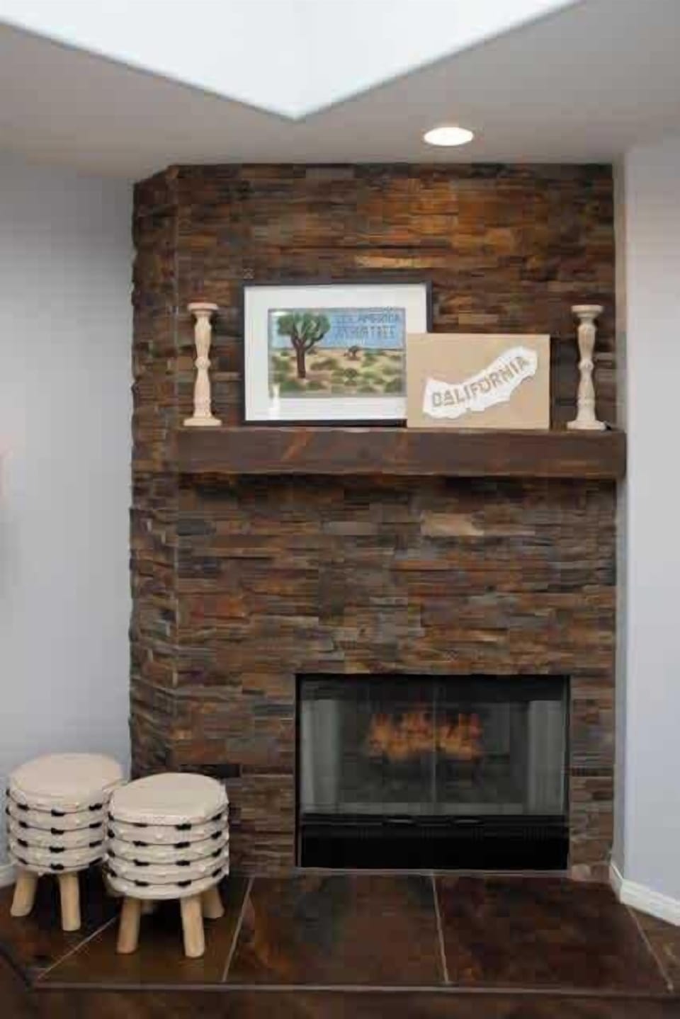 Trendy living room photo  with a stylish fireplace.