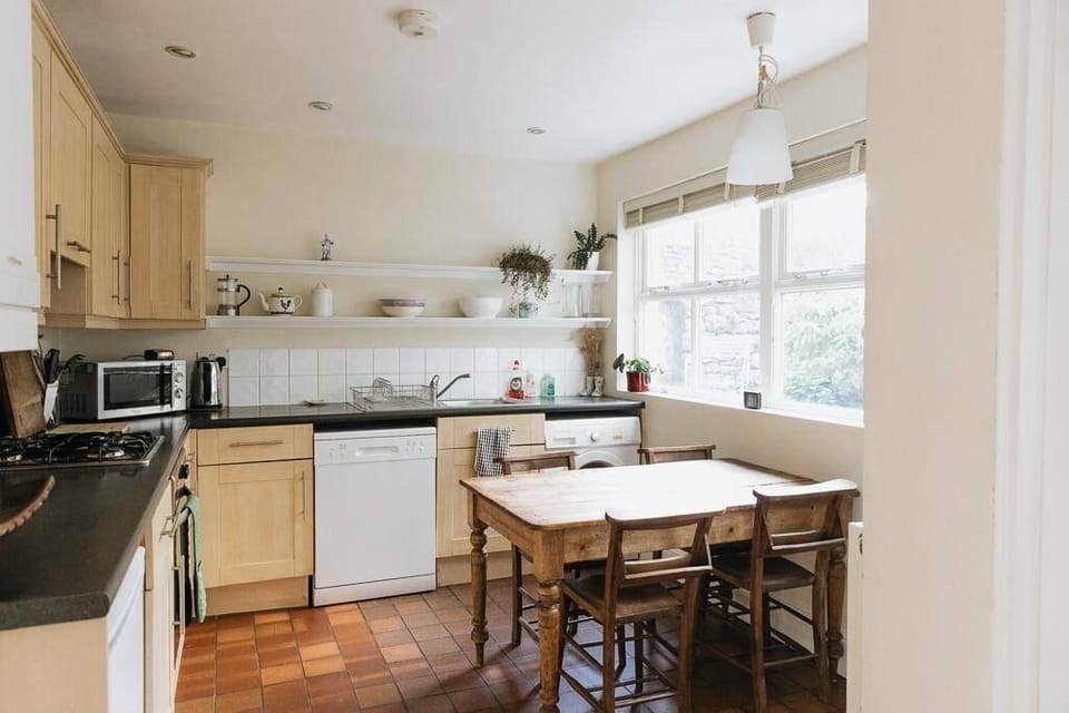 Kitchen with amenities and dining table and seating.