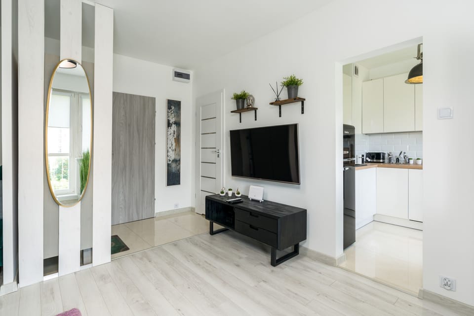 Another view of the living room, emphasizing the spacious and airy design with natural light.
