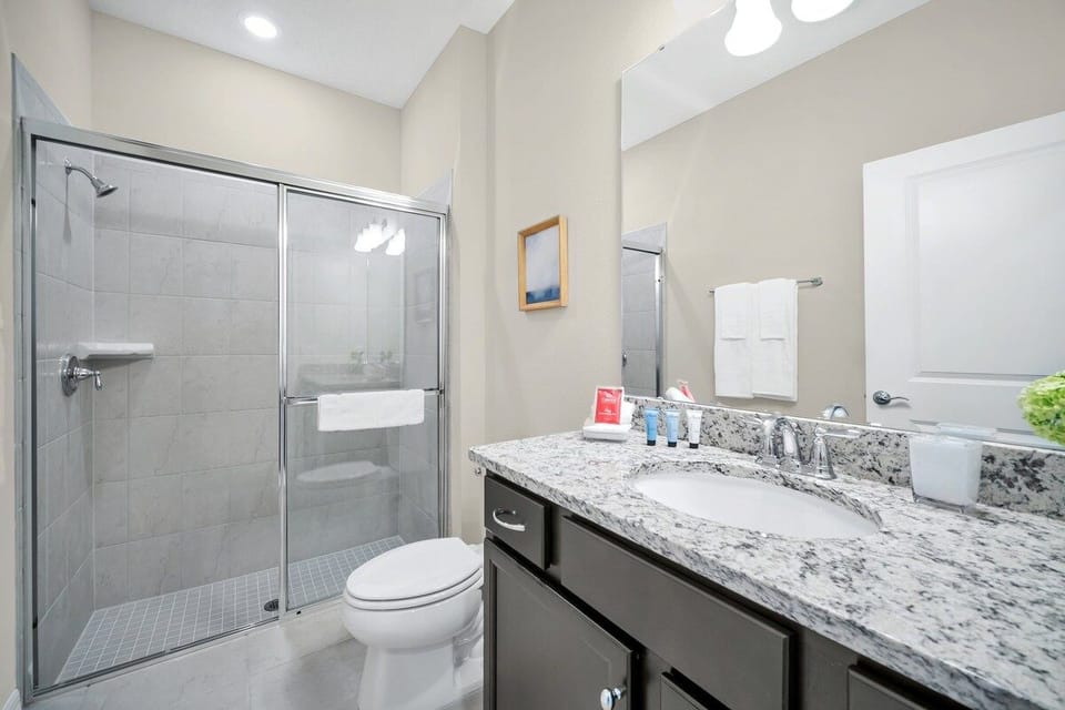 Lush Bathroom of the townhouse in Polk County, Florida - Turn your shower into a radiant haven with a modern glass-enclosed sanctuary - Chic vanity featuring a spacious mirror and plenty of storage - All bathroom essentials readily available