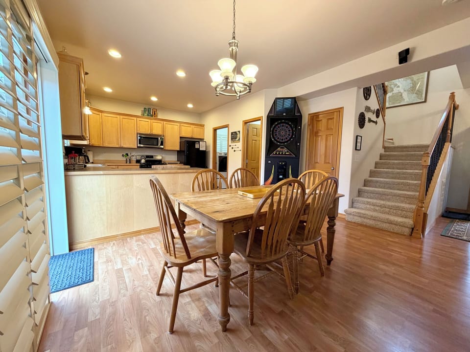 Dining room with slider to fenced back yard. There is also a dart game available