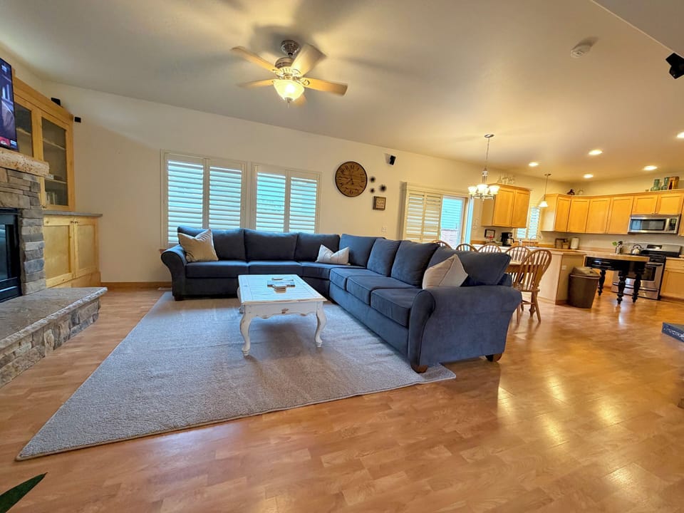 Living Room features  a new couch, Smart TV, gas fireplace, books and games.
