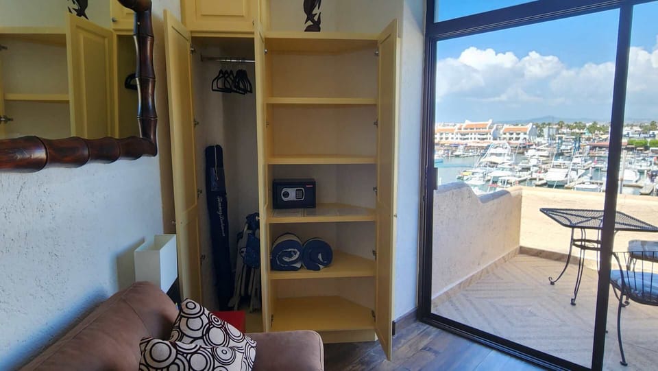 Clothes closet with safe, beach umbrella and beach chairs