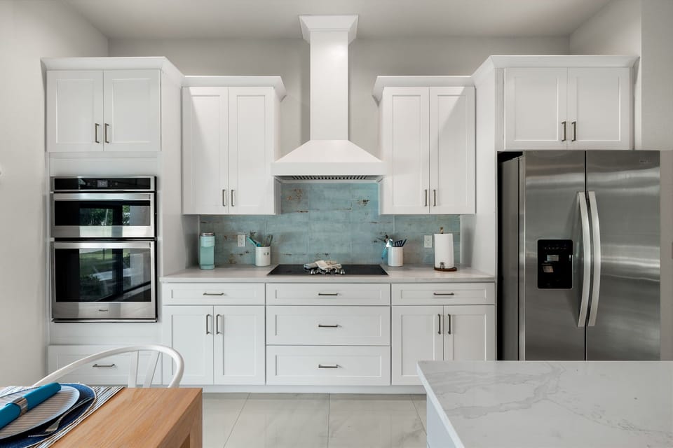 The modern kitchen has stainless steel appliances